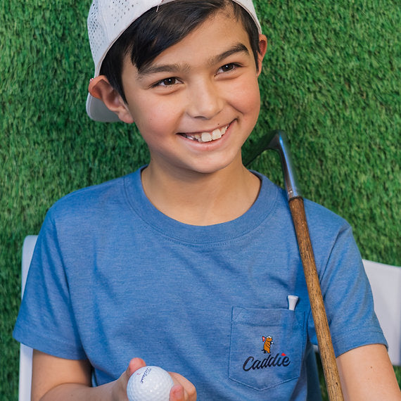 Boy youth model lifestyle photo wearing Caddie Retriever Pro Tee in Saltwater Blue RC117Y