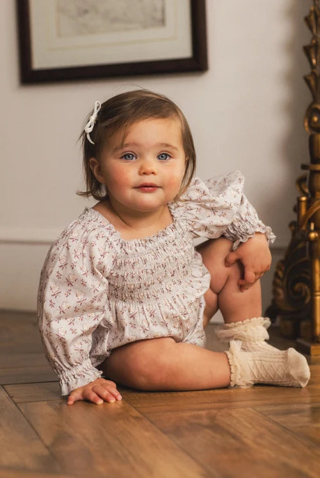 Baby modeling the Noralee Mini Ribbon Bows | Black, Ivory in "Ivory"
