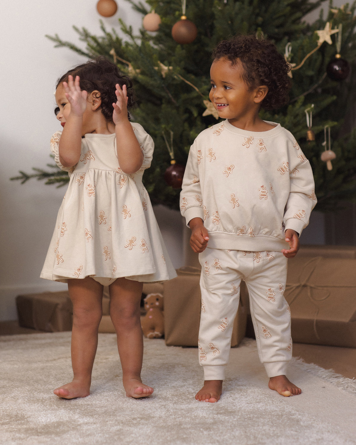 Quincy Mae Darla Dress in Gingerbread , Quincy Mae Relaxed Fleece Baby Sweatshirt in Gingerbread, and Quincy Mae Relaxed Fleece Baby Sweatpant in Gingerbread family matching baby styles model photo