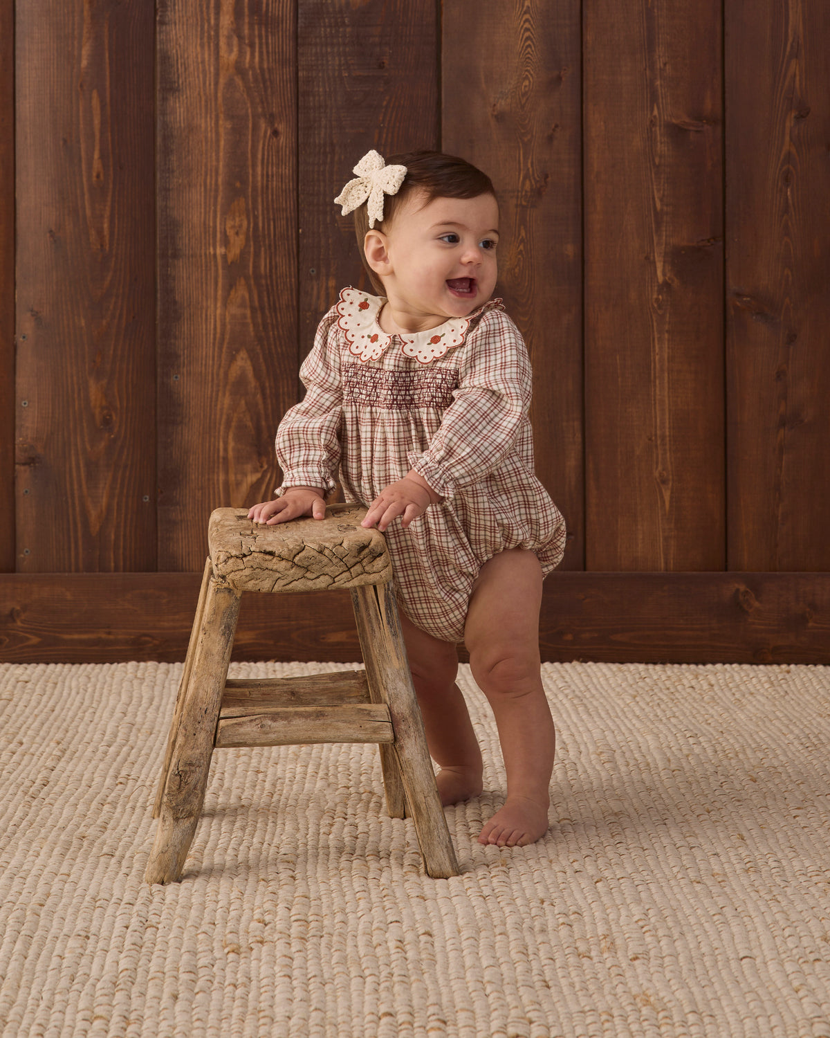 Quincy Mae Baby Callie Romper in Christmas Plaid studio baby model photo styled with Quincy Mae Baby Crochet Bow in Natural