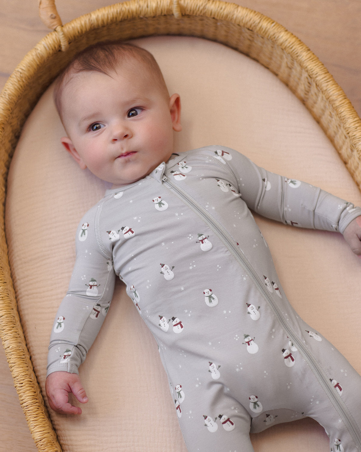Baby boy wearing Quincy Mae Baby Bamboo Zip Footie in Snowman