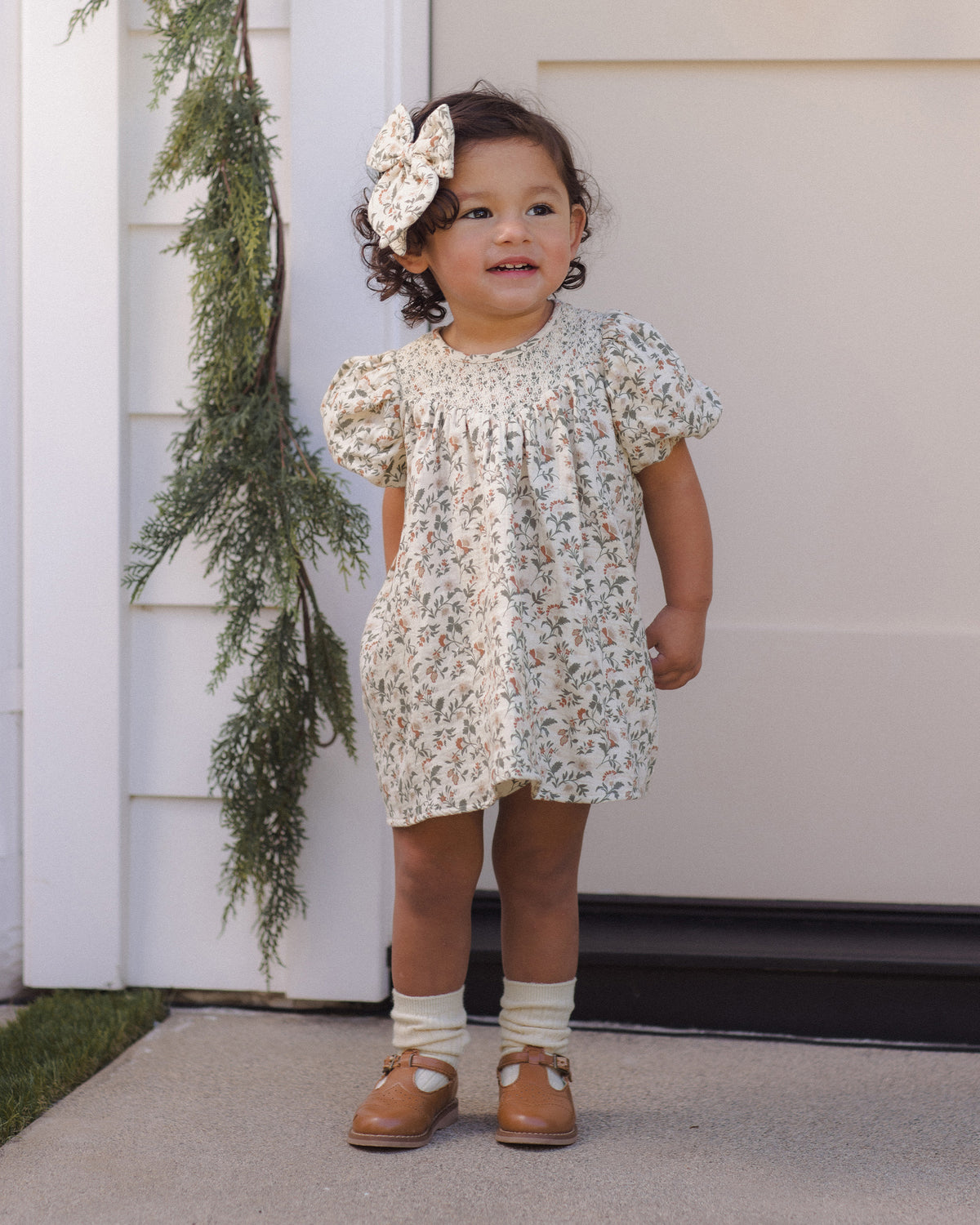 Quincy Mae Carina Baby Dress in Holiday Floral full length lifestyle model photo