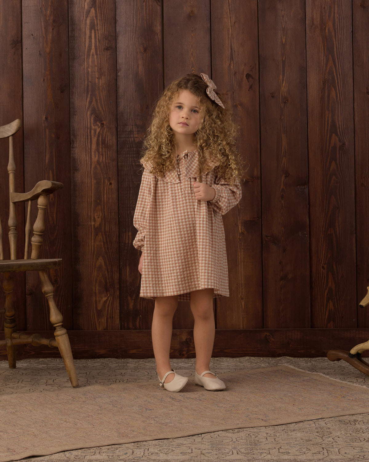 Girl wearing the Rylee + Cru Collette Mini Dress | Fawn Gingham styled with the matching bow