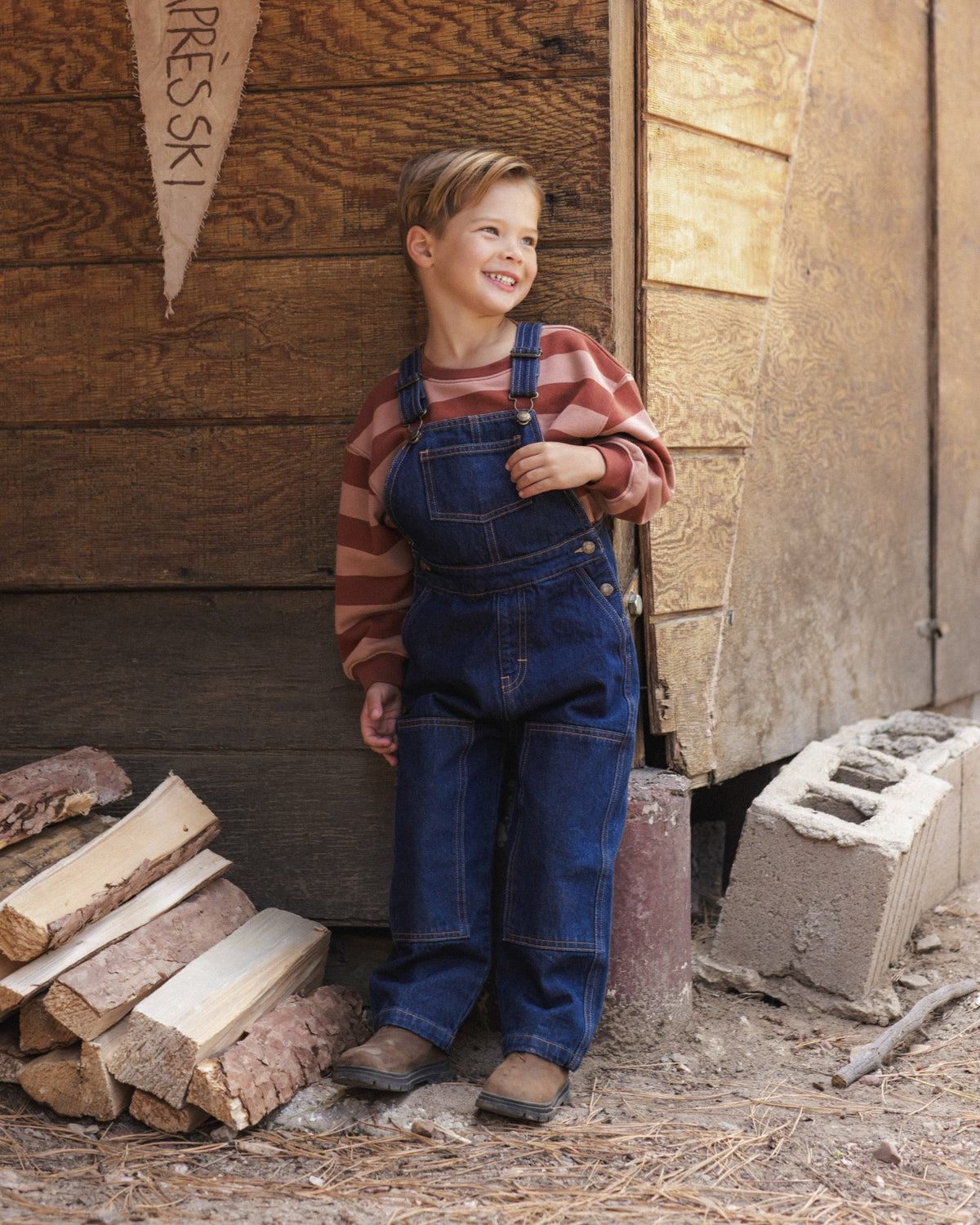 Boy wearing the Rylee + Cru Oversized Sweatshirt | Brick + Clay Stripe
