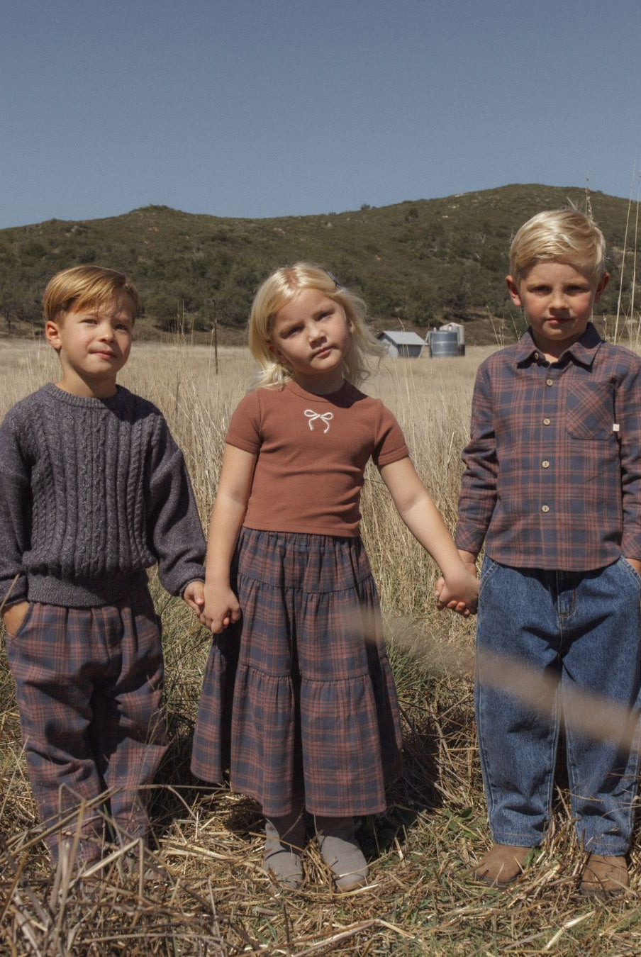 Three children. The boy on the left is wearing the Rylee + Cru Aspen Sweater | Midnight