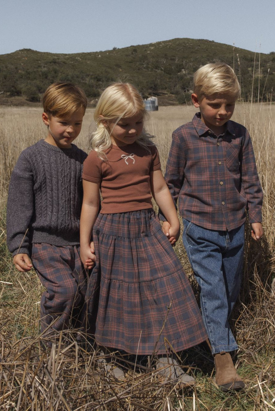 Three children. The boy on the left is modeling the Rylee + Cru Aspen Sweater | Midnight
