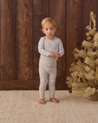 Baby wearing Quincy Mae Baby Bamboo Pajama Set in Snowman styled studio photo