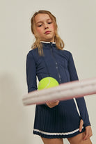 Styled shot of girl with her tennis gear, wearing the Parfum de Fit Airform Accent Jacket | Midnight