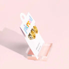Pierced Co. Zebra Stripe Huggies Earrings in packaging, side view