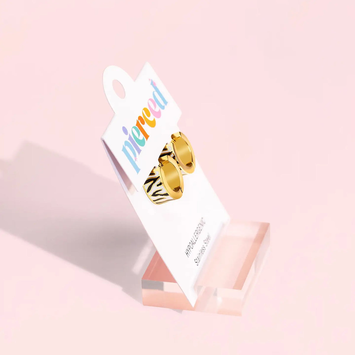 Pierced Co. Zebra Stripe Huggies Earrings in packaging, side view