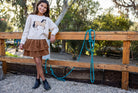 Girl modeling the Feather 4 Arrow Camille Horse Sweater