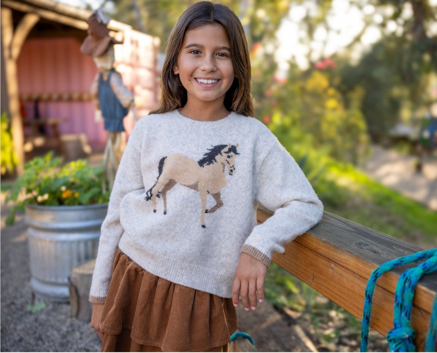 Close shot of girl modeling the Feather 4 Arrow Camille Horse Sweater