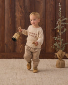 boy in Knit Baby Toddler Sweater in Santa Baby and Quincy Mae Luca Pant in Latte model photo