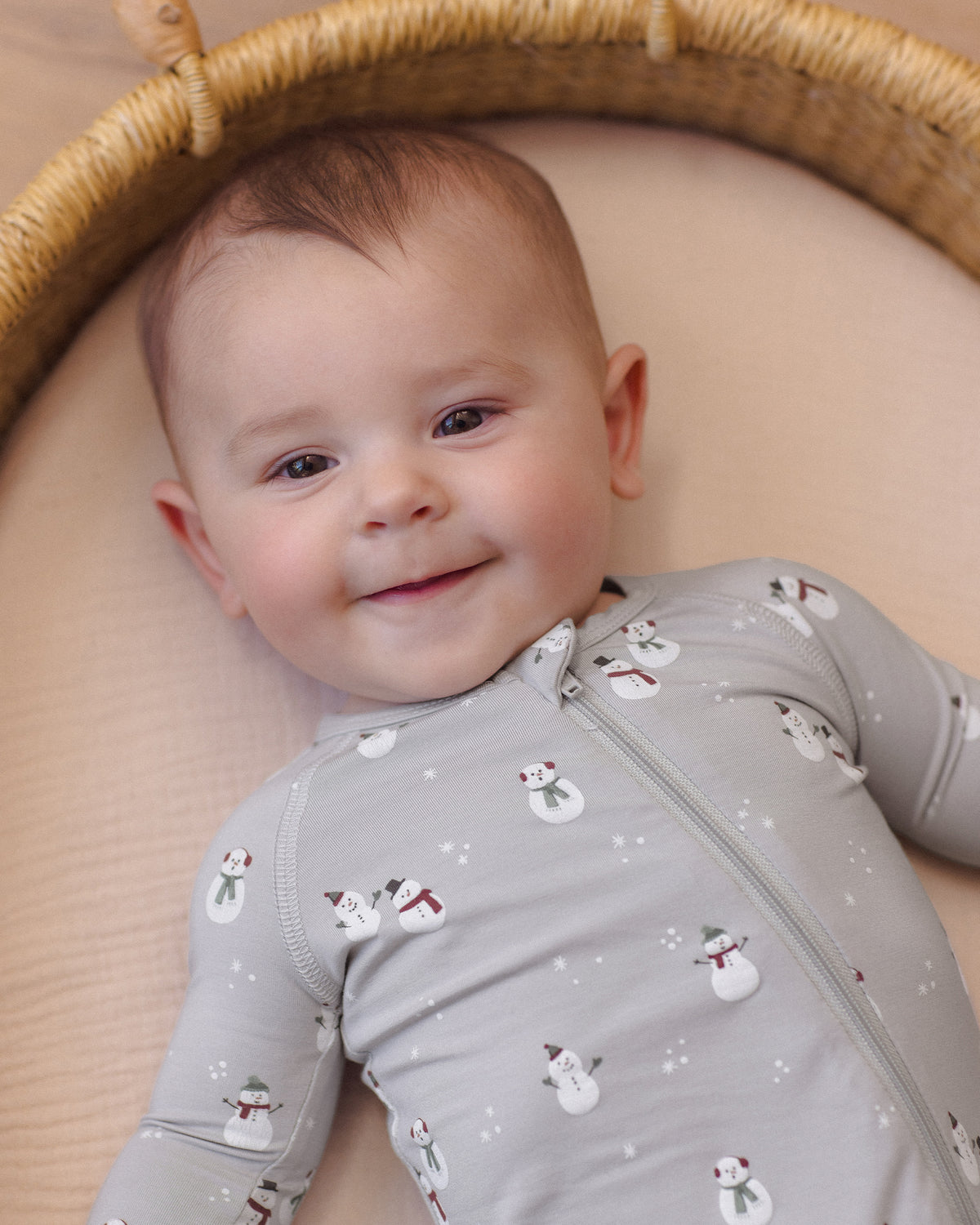 Baby boy wearing Quincy Mae Baby Bamboo Zip Footie in Snowman close up portrait 