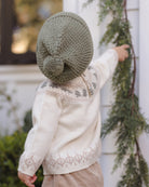 Toddler model wearing Quincy Mae Baby Rex Sweater in Tree Fair Isle and Quincy Mae Beanie in Spruce back to camera angle