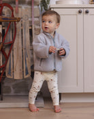 Styled baby model wearing Quincy Mae Baby Bamboo Pajama Set in Forest Friends
