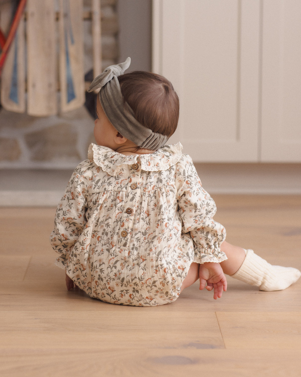Quincy Mae Callie Romper in Holiday Floral styled model back to camera angle