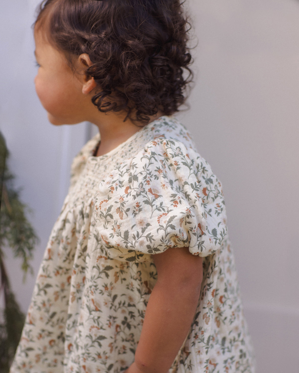 Styled Quincy Mae Carina Baby Dress in Holiday Floral close up detail lifestyle photo