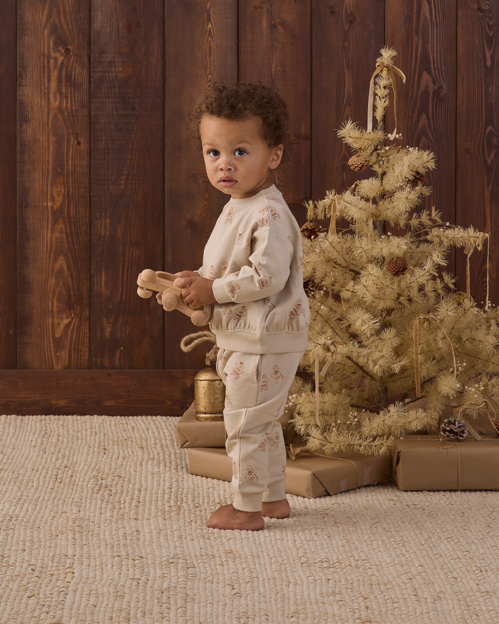 Quincy Mae Relaxed Fleece Baby Sweatshirt in Gingerbread and Quincy Mae Relaxed Fleece Baby Sweatpant in Gingerbread full length studio model side angle photo