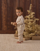 Quincy Mae Relaxed Fleece Baby Sweatshirt in Gingerbread and Quincy Mae Relaxed Fleece Baby Sweatpant in Gingerbread full length studio model side angle photo
