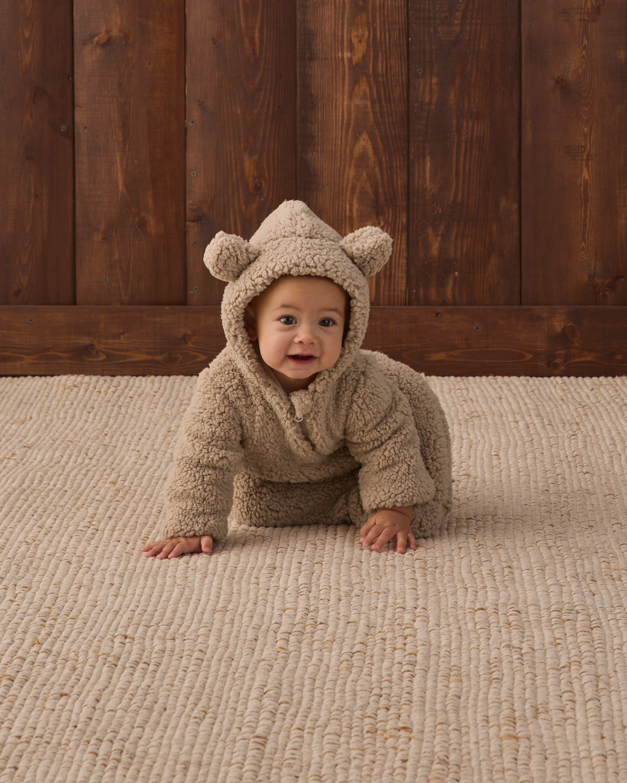 Studio baby model wearing Quincy Mae Baby Bear Jumpsuit in Latte