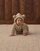 Studio baby model wearing Quincy Mae Baby Bear Jumpsuit in Latte