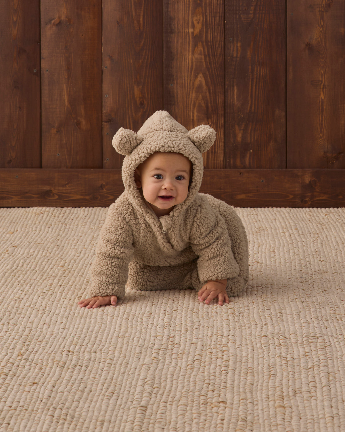 Studio baby model wearing Quincy Mae Baby Bear Jumpsuit in Latte