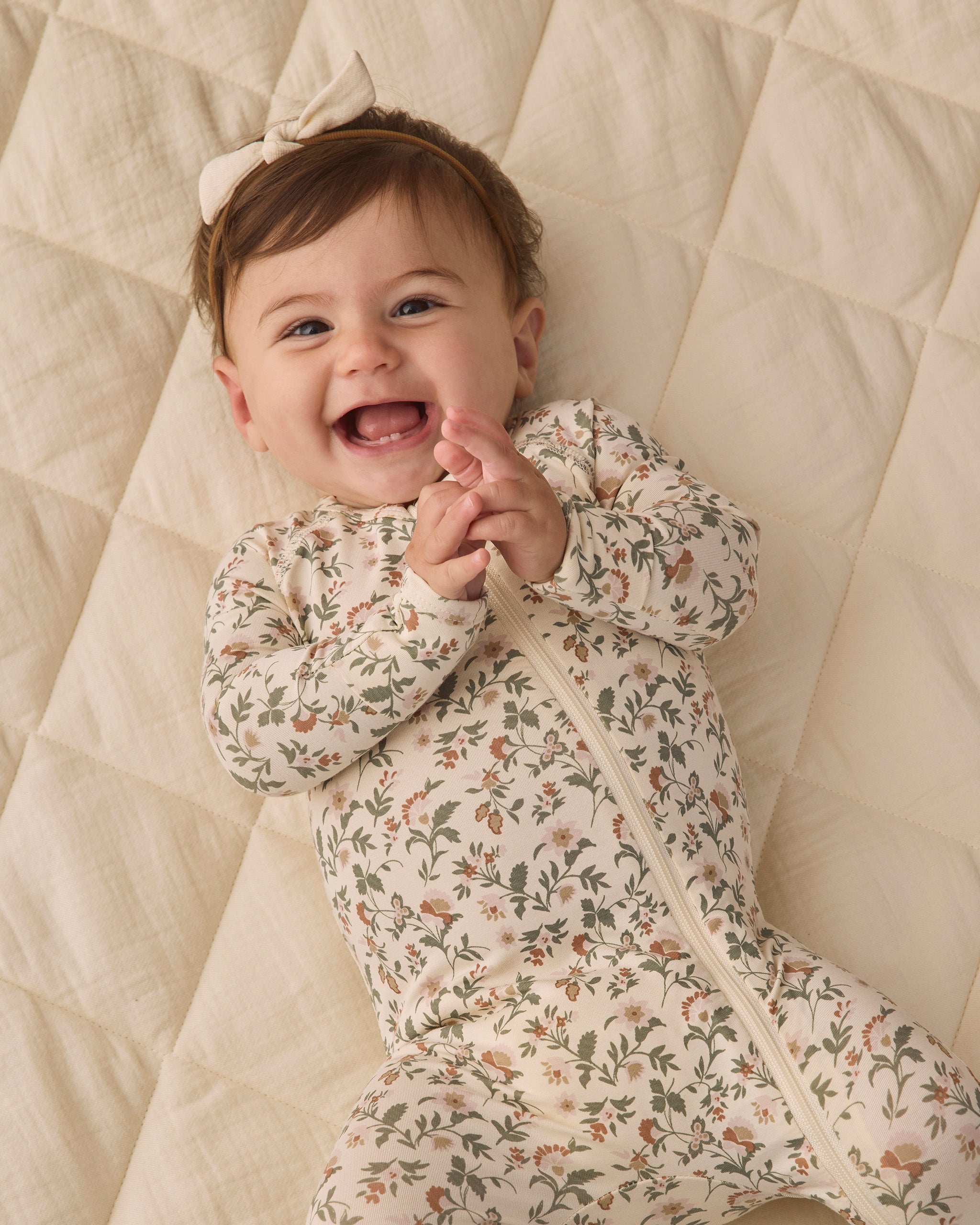 Quincy Mae Baby Bamboo Zip Footie in Holiday Floral  Smiling Baby Model Portrait