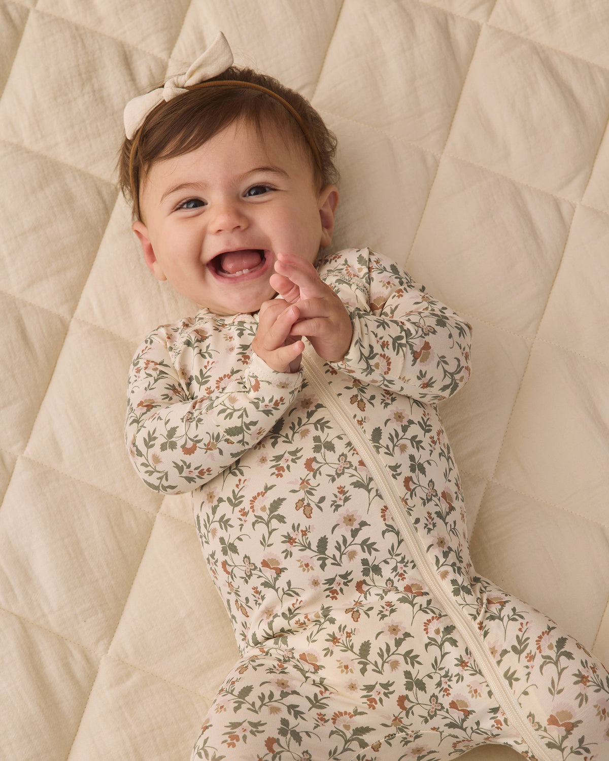 Quincy Mae Baby Bamboo Zip Footie in Holiday Floral  Smiling Baby Model Portrait