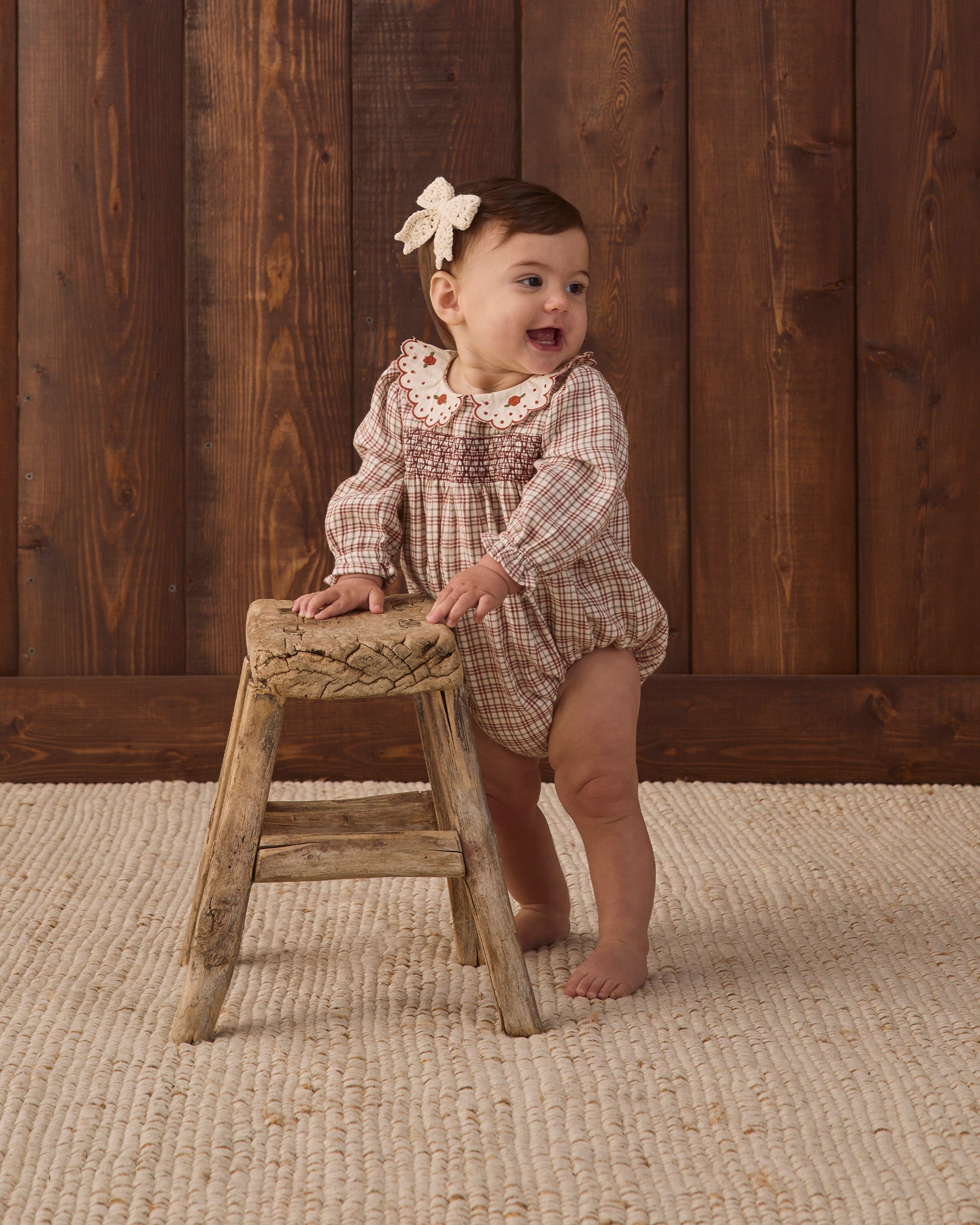 Quincy Mae Baby Callie Romper in Christmas Plaid studio baby model photo styled with Quincy Mae Baby Crochet Bow in Natural
