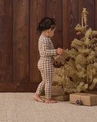 Styled studio baby model in Quincy Mae Baby Bamboo Pajama Set in Redwood Check back to camera angle