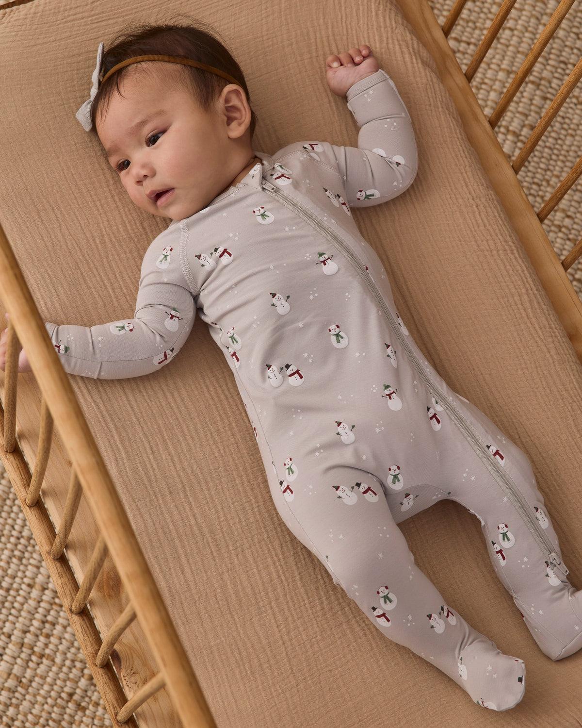 Baby girl model in Quincy Mae Baby Bamboo Zip Footie in Snowman