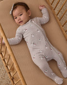 Baby girl model wearing Quincy Mae Baby Bamboo Zip Footie in Snowman 