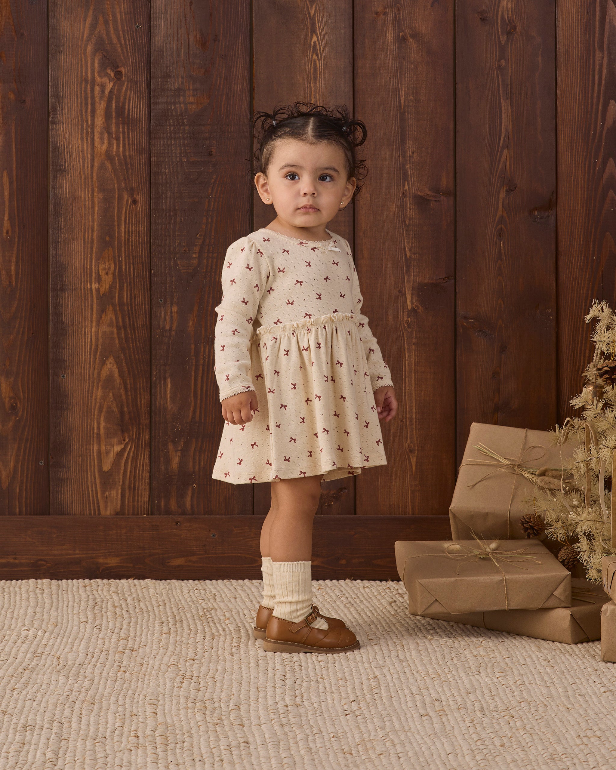 Quincy Mae Alda Dress in Red Bows full length 3/4 profile model photo
