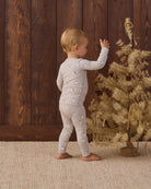 Baby model back to camera angle wearing Quincy Mae Baby Bamboo Pajama Set in Snowman