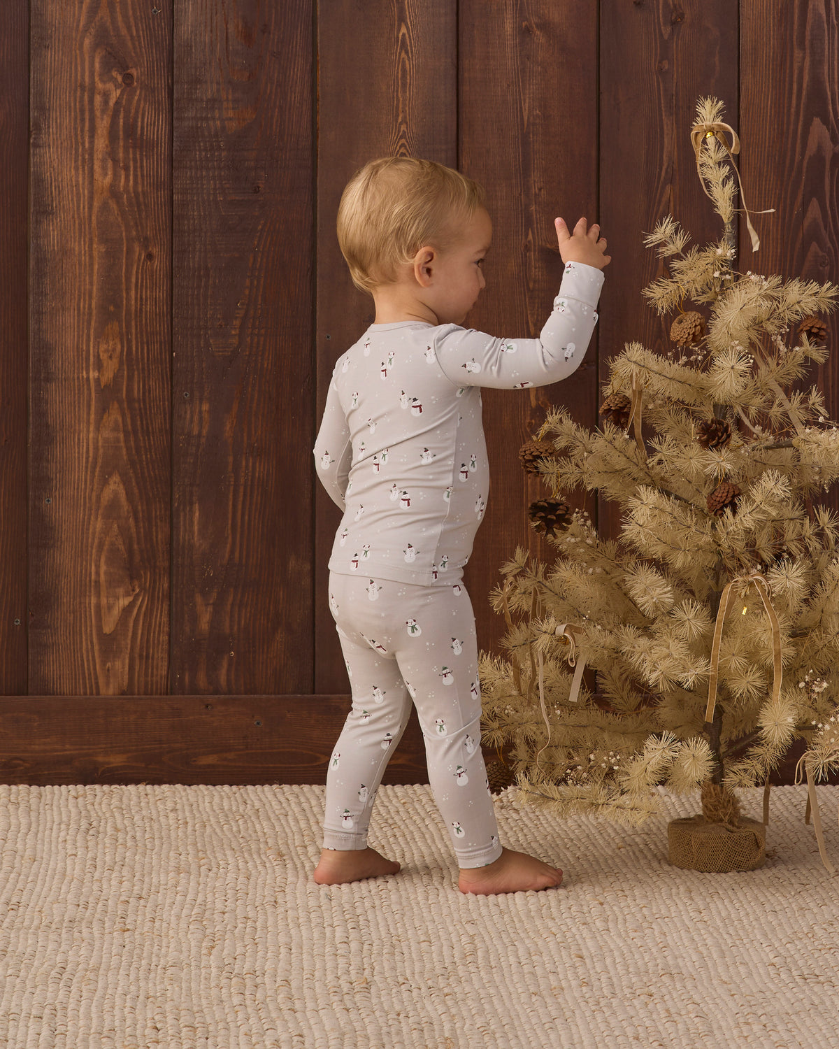 Baby model back to camera angle wearing Quincy Mae Baby Bamboo Pajama Set in Snowman
