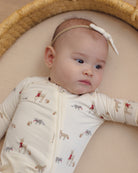 Baby model wearing Quincy Mae Baby Bamboo Zip Footie in Forest Friends portrait
