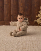 Baby model showing hood of Quincy Mae Baby Bear Jumpsuit in Latte
