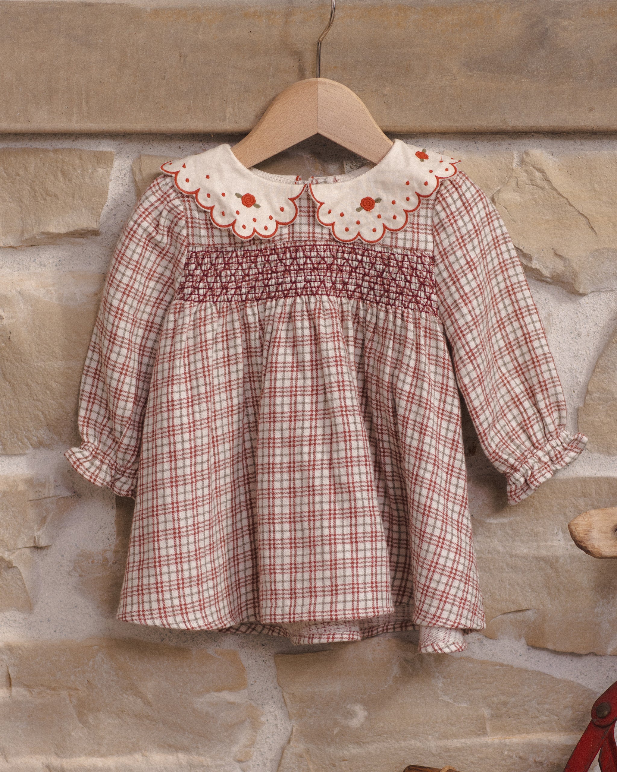 Styled Quincy Mae Baby Callie Dress in Christmas Plaid on Hanger