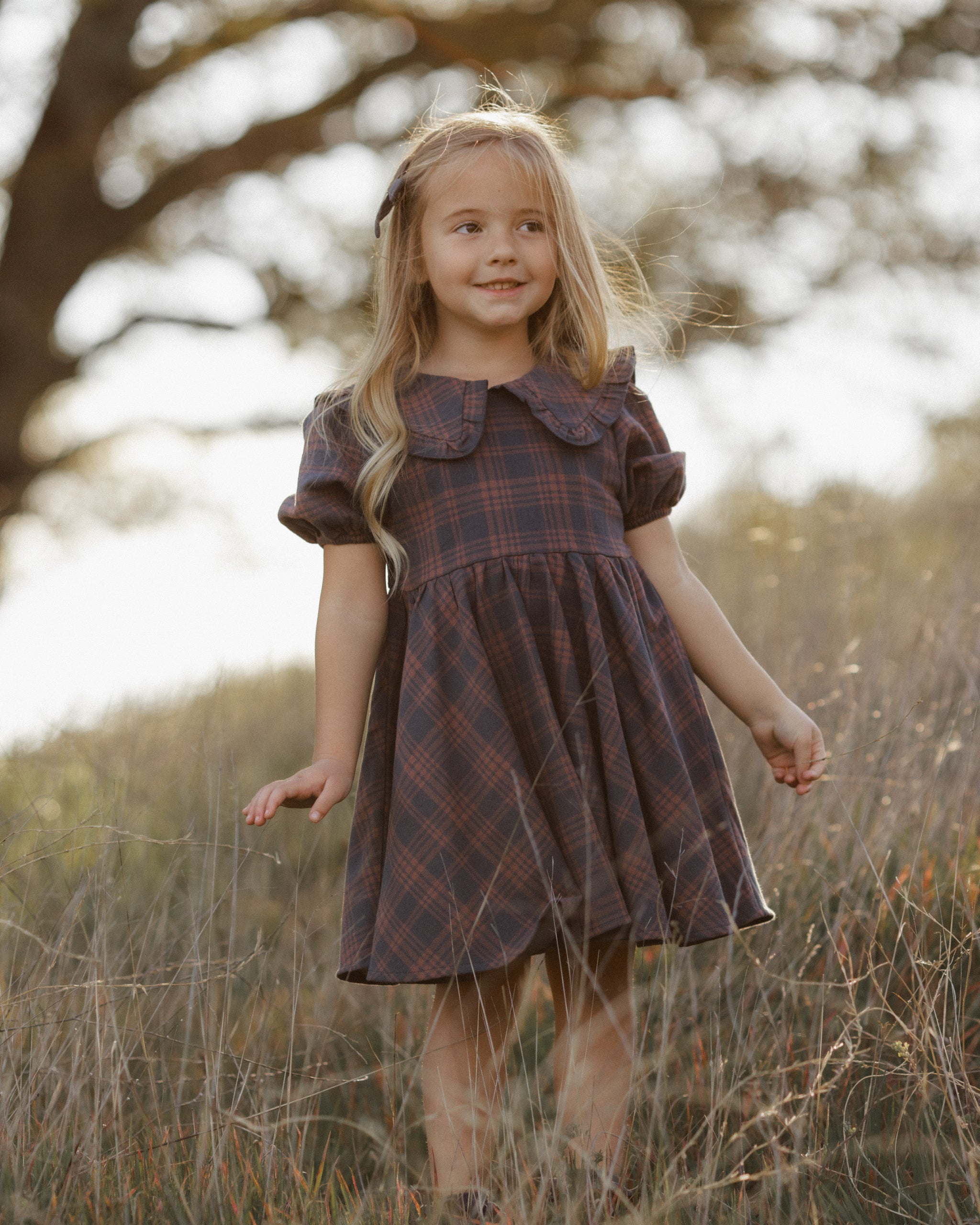 Girl outdoors modeling the Rylee + Cru Camille Dress | Midnight Plaid