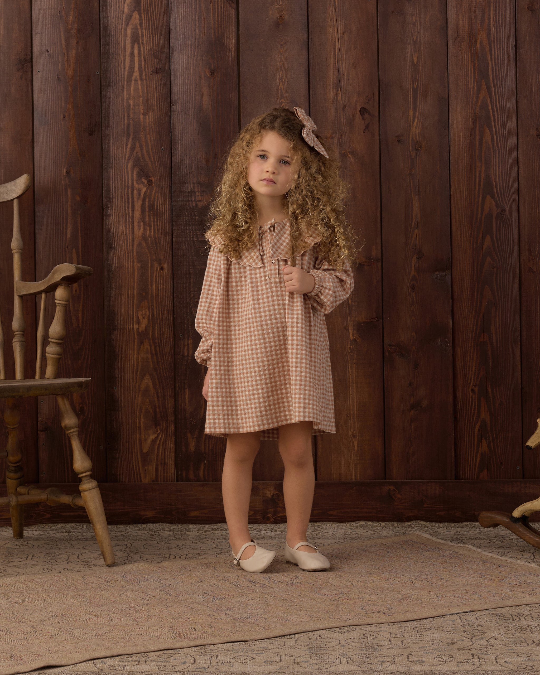 Girl wearing the Rylee + Cru Collette Mini Dress | Fawn Gingham styled with the matching bow