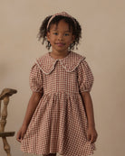 Close-up image of young girl modeling the Rylee + Cru Camille Dress | Brick Check