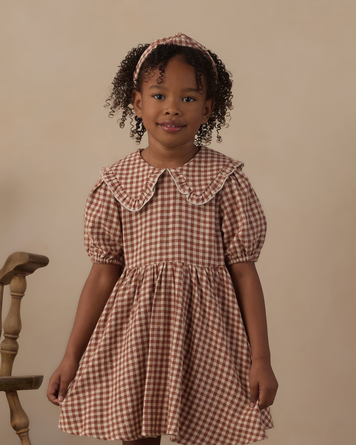 Close-up image of young girl modeling the Rylee + Cru Camille Dress | Brick Check