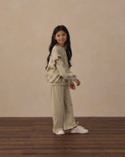 Side view of girl modeling the Ruffle Sweatshirt | Big Daisy from Rylee + Cru