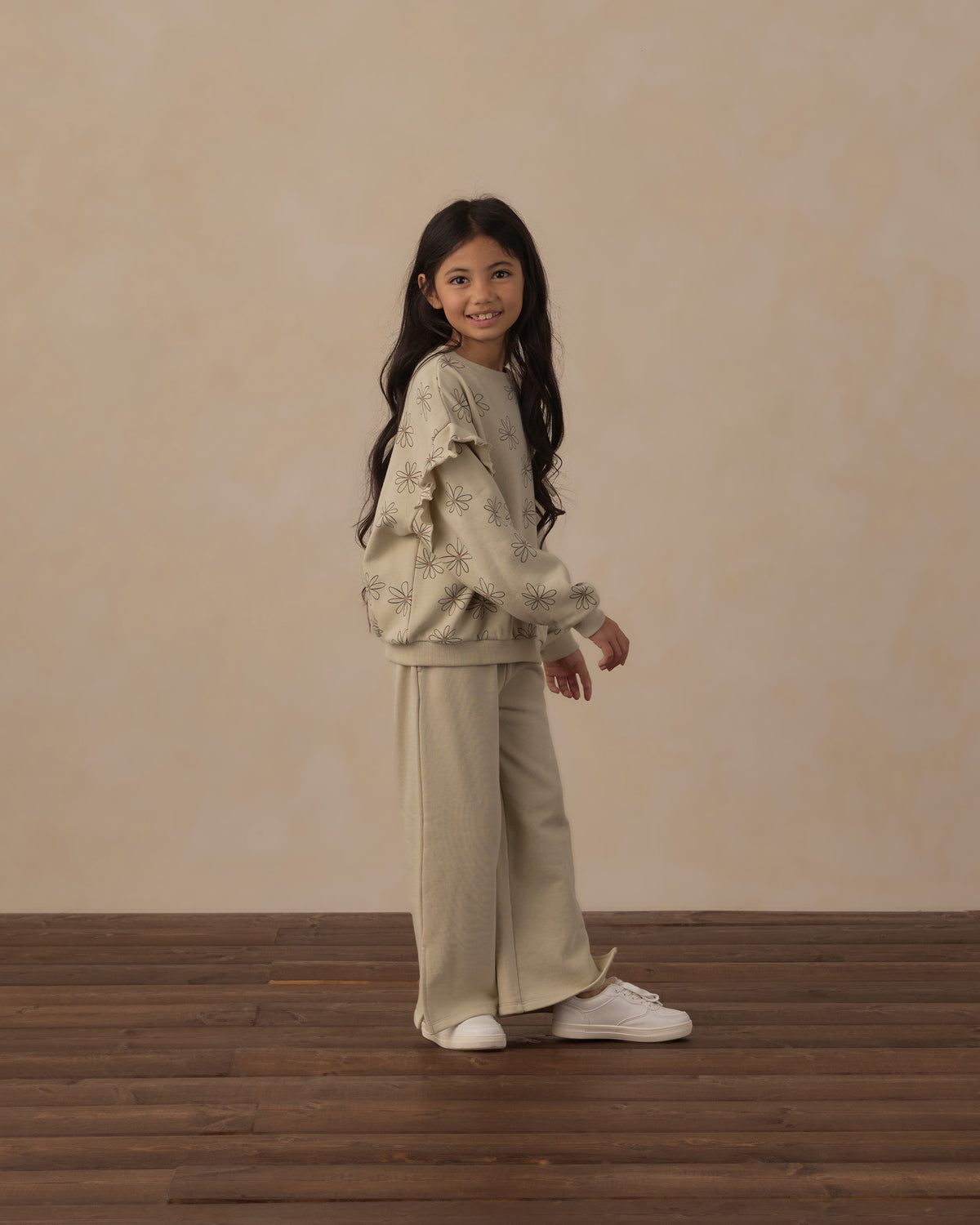 Side view of girl modeling the Ruffle Sweatshirt | Big Daisy from Rylee + Cru