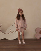 Smiling young girl wearing the Rylee + Cru Boxy Pullover | Swans