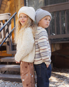 Girl and a boy standing outside. The boy is wearing the Rylee + Cru Jacques Sweater | Dusty Blue Stripe
