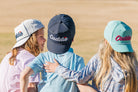 Youth Caddie Performance Rope Hat | White & Navy lifestyle model photo, back to camera angle