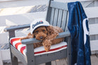 Model lifestyle photo of Youth Solid Bill Hat in White & Navy by Caddie