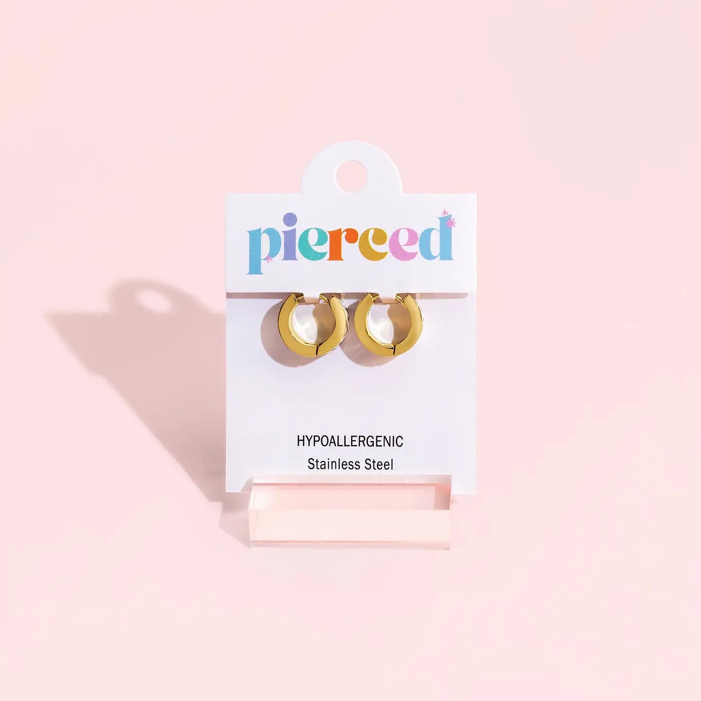 Pierced Co. Zebra Stripe Huggies Earrings flat lay in packaging